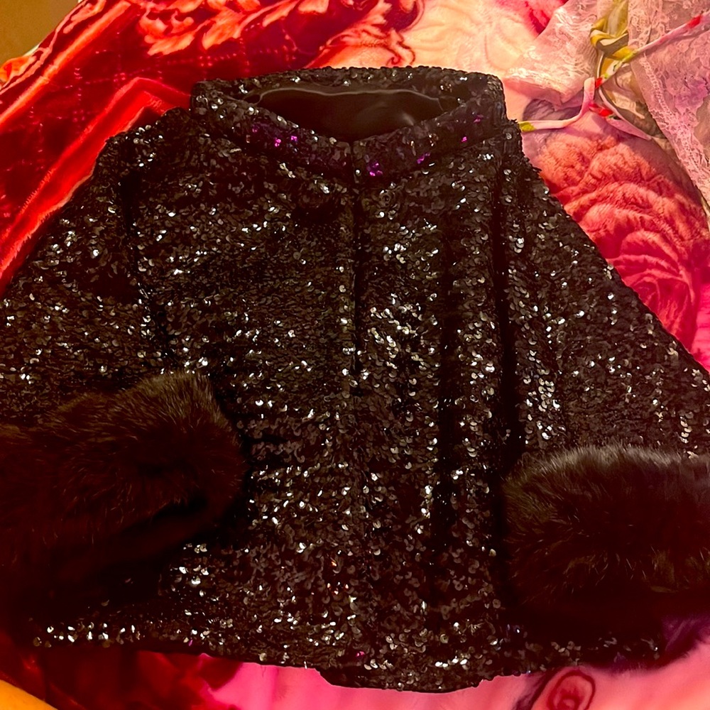 Black sequence fits like a medium very very beautiful it’s been in the fam.